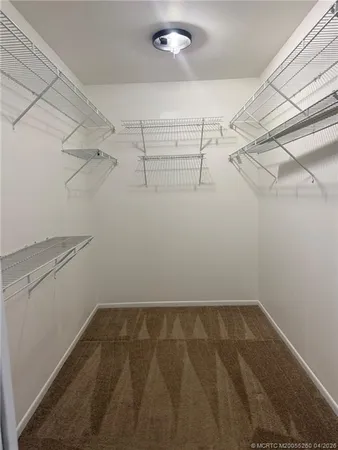 a spacious bathroom with double vanity and a mirror