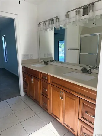 a bathroom with a double vanity sink toilet and a mirror