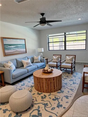 a living room with furniture a rug and a window