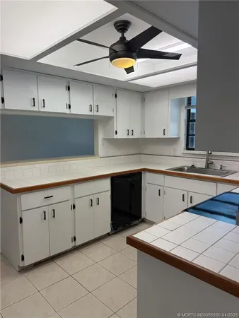 a kitchen with cabinets appliances and a sink