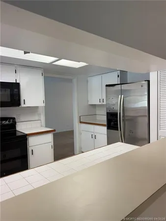 a kitchen with a refrigerator and a sink