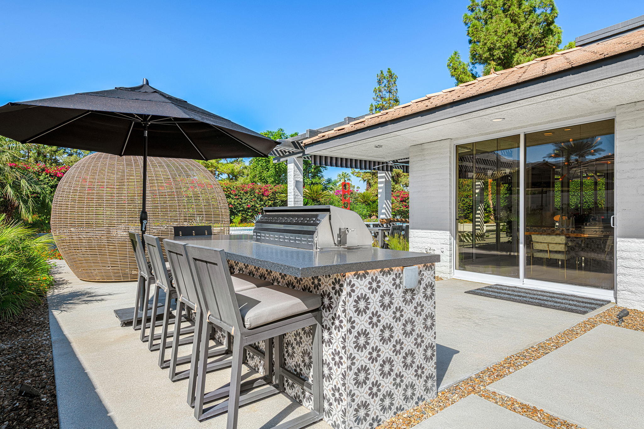 30 Mayfair Drive Rancho Mirage, CA 92270 - Photo 28 of 30 a patio with a table and chairs under an umbrella