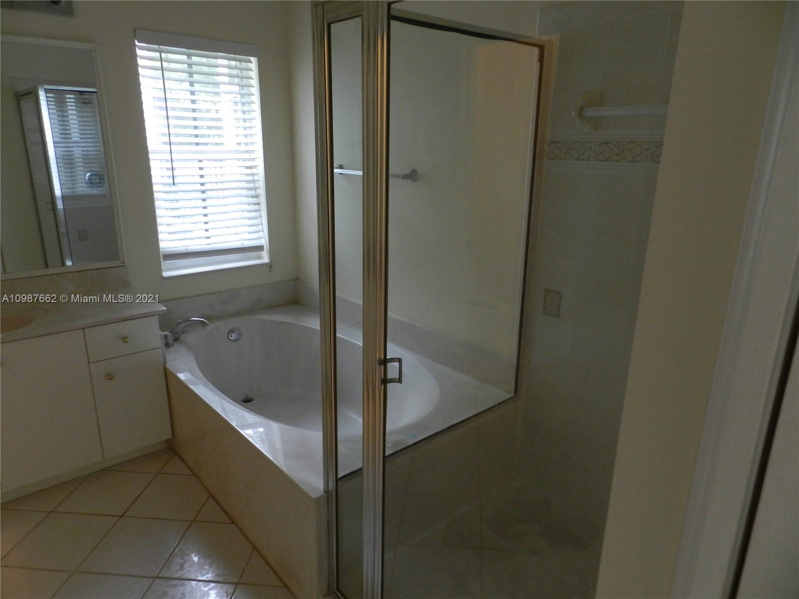 1234 Chenille Circle Weston, FL 33327 - Photo 25 of 35 a bathroom with a bathtub and a shower