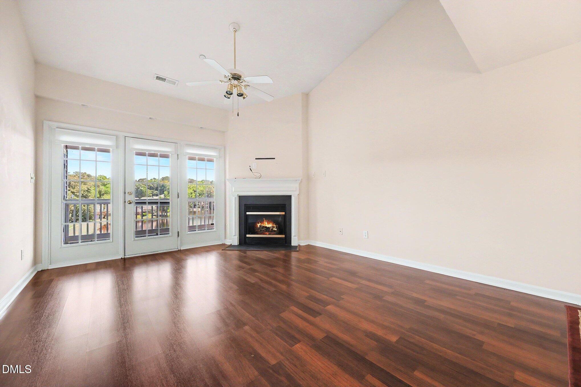 132 Springfork Drive Cary, NC 27513 - Photo 11 of 28 a view of an empty room with wooden floor and a window
