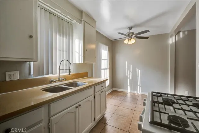 a kitchen with a sink and a refrigerator