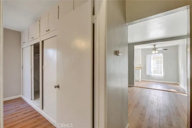 a view of hallway with wooden floor