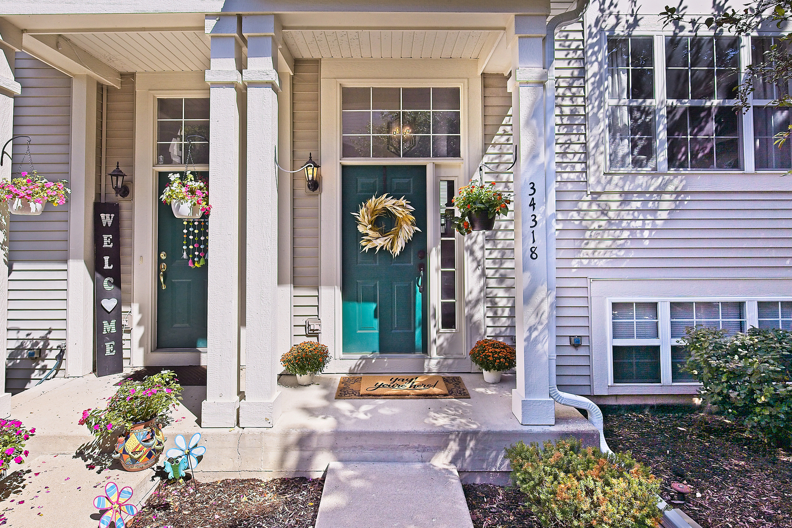 34318 North Barberry Road Round Lake Beach, IL 60073 - Photo 1 of 26 front view of a brick house with a large windows and a potted plant