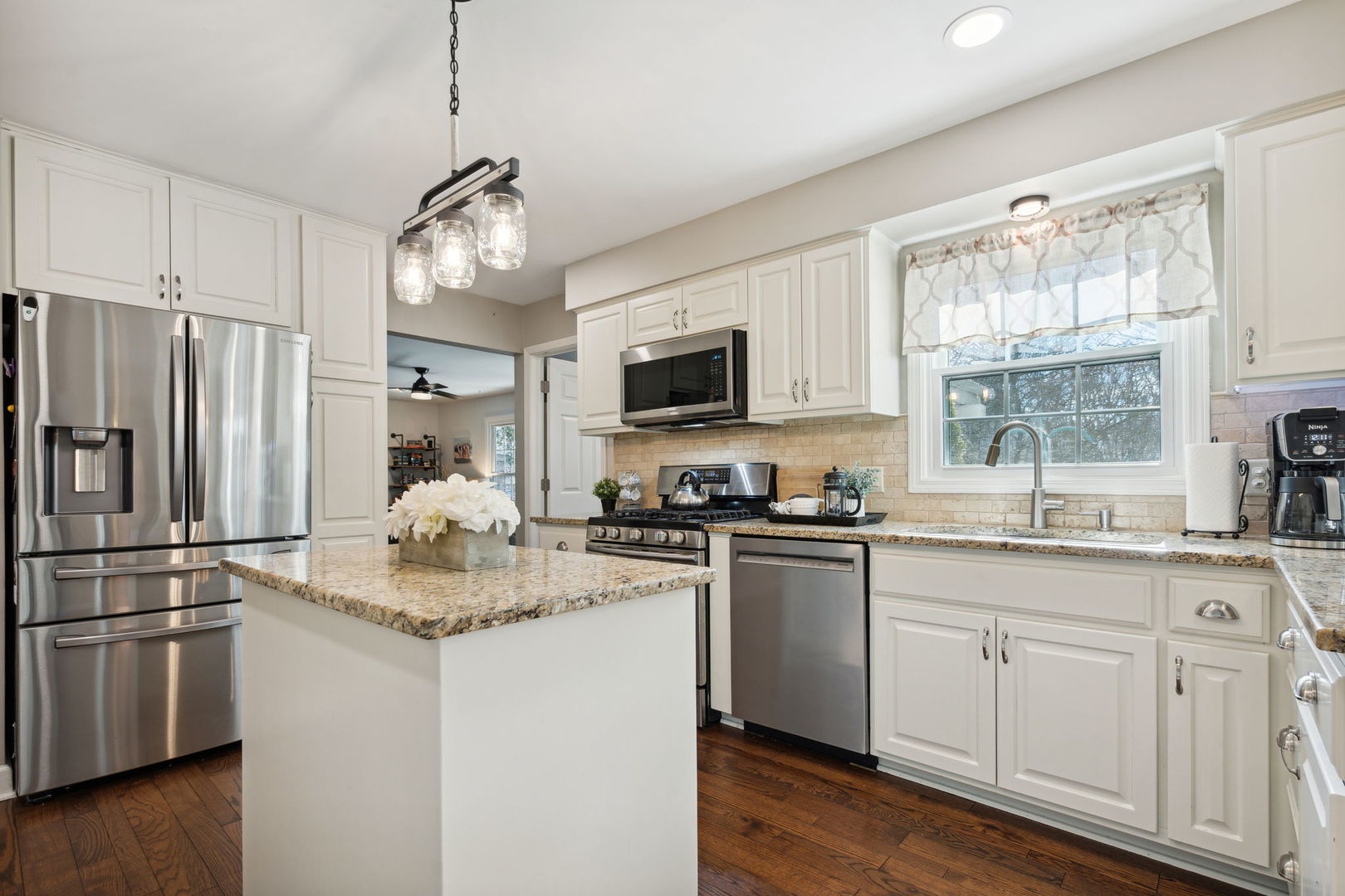 1246 Edward Road Naperville, IL 60540 - Photo 8 of 21 a kitchen with kitchen island granite countertop stainless steel appliances a sink stove and refrigerator