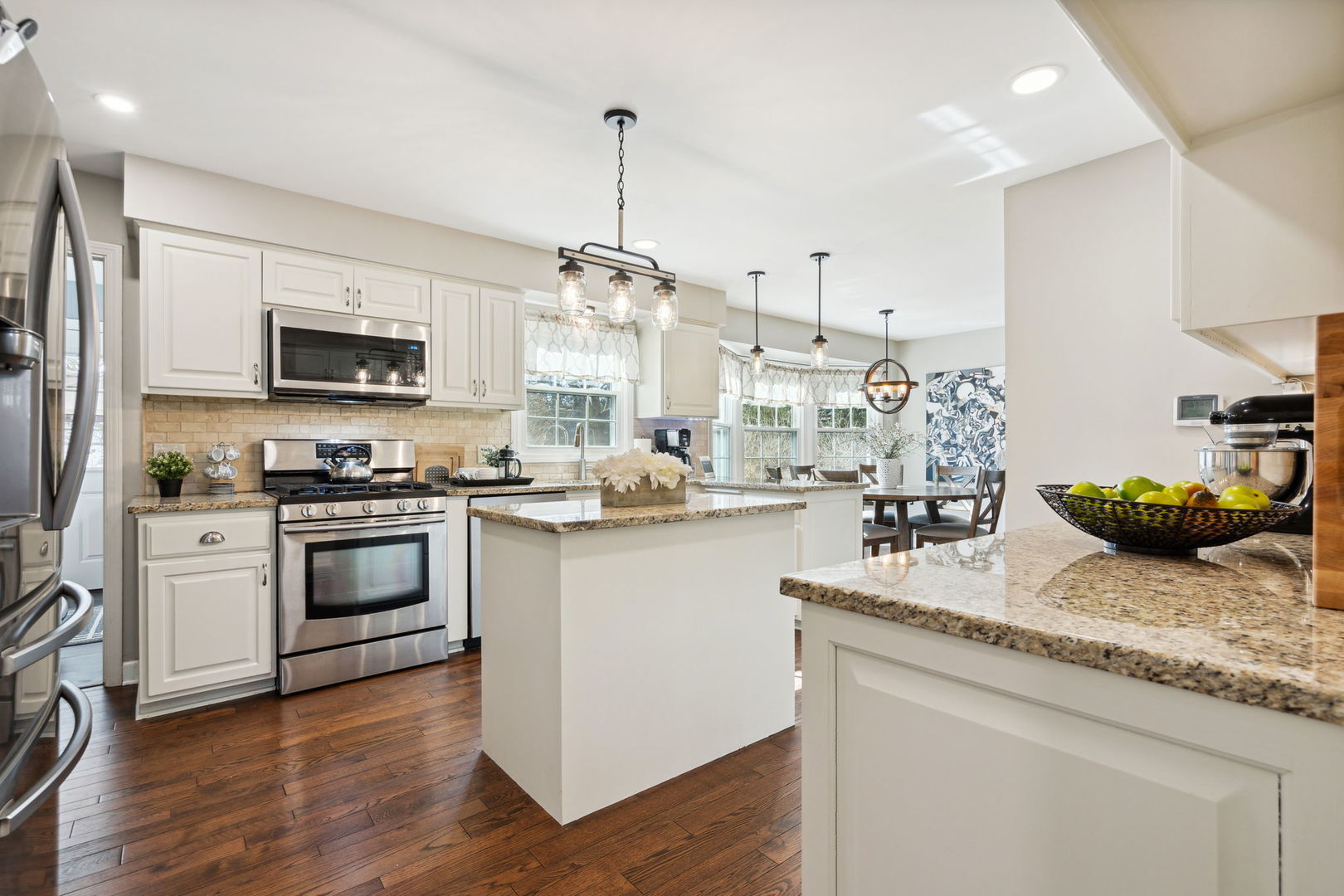 1246 Edward Road Naperville, IL 60540 - Photo 9 of 21 a kitchen with granite countertop stainless steel appliances and wooden floor