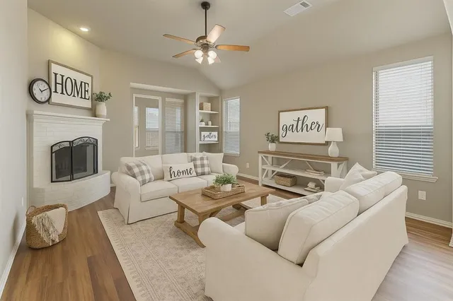 a living room with furniture and a fireplace