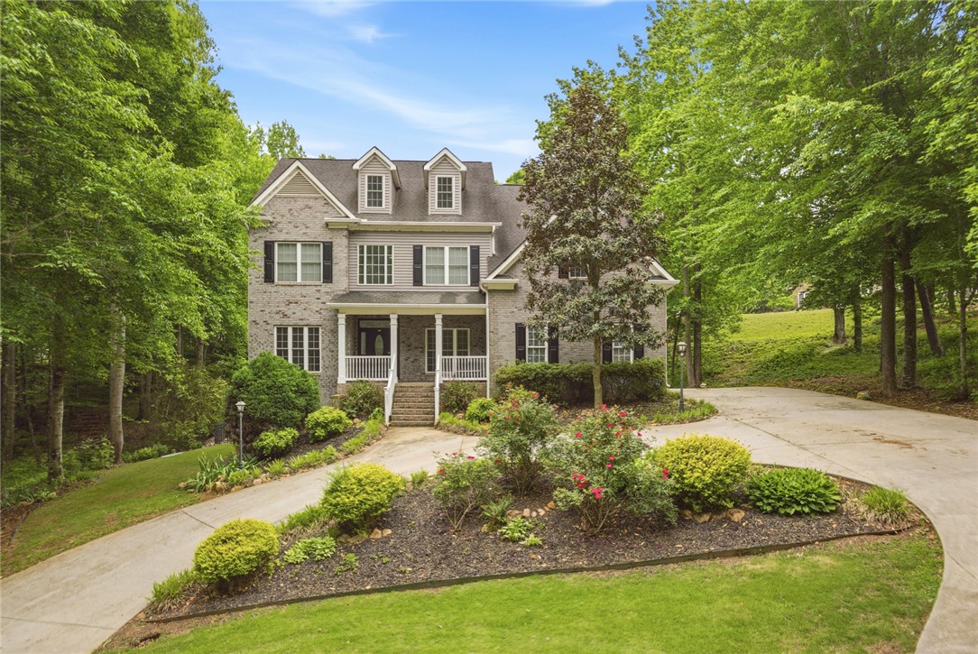 207 Devonhurst Drive Seneca, SC 29678 - Photo 2 of 50 This charming home sits amidst lush greenery, offering privacy and a serene escape.