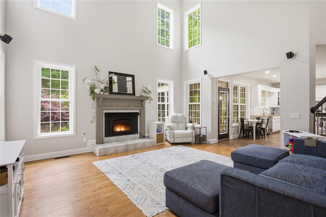 207 Devonhurst Drive Seneca, SC 29678 - Photo 3 of 50 This bright living area features a fireplace and abundant natural light, seamlessly flowing into the dining and kitchen spaces.