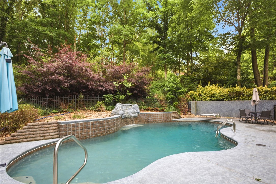 207 Devonhurst Drive Seneca, SC 29678 - Photo 39 of 50 This private outdoor oasis features a private pool and waterfall, perfect for relaxation and entertaining.
