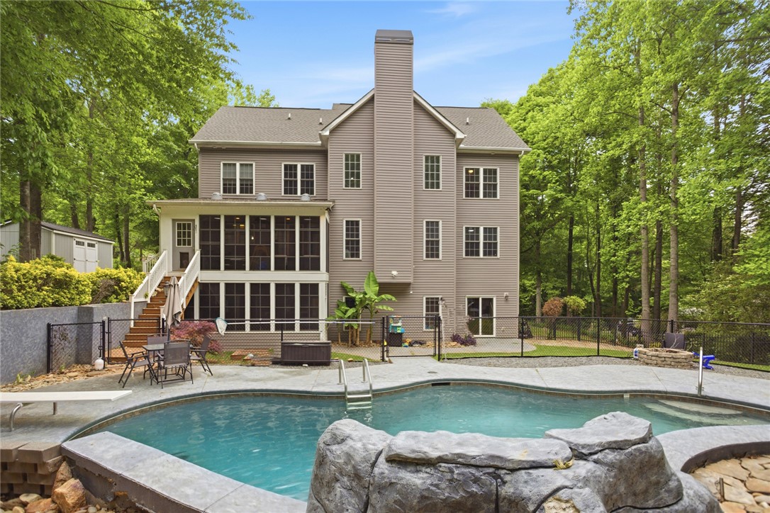 207 Devonhurst Drive Seneca, SC 29678 - Photo 40 of 50 This residence boasts a private backyard oasis with a refreshing pool, perfect for outdoor living.