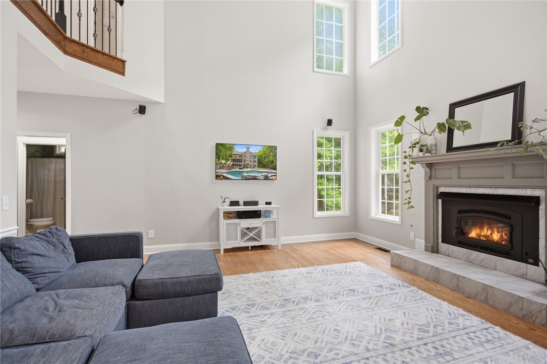 207 Devonhurst Drive Seneca, SC 29678 - Photo 5 of 50 This bright living area features towering ceilings and an inviting fireplace, creating a grand yet cozy atmosphere.