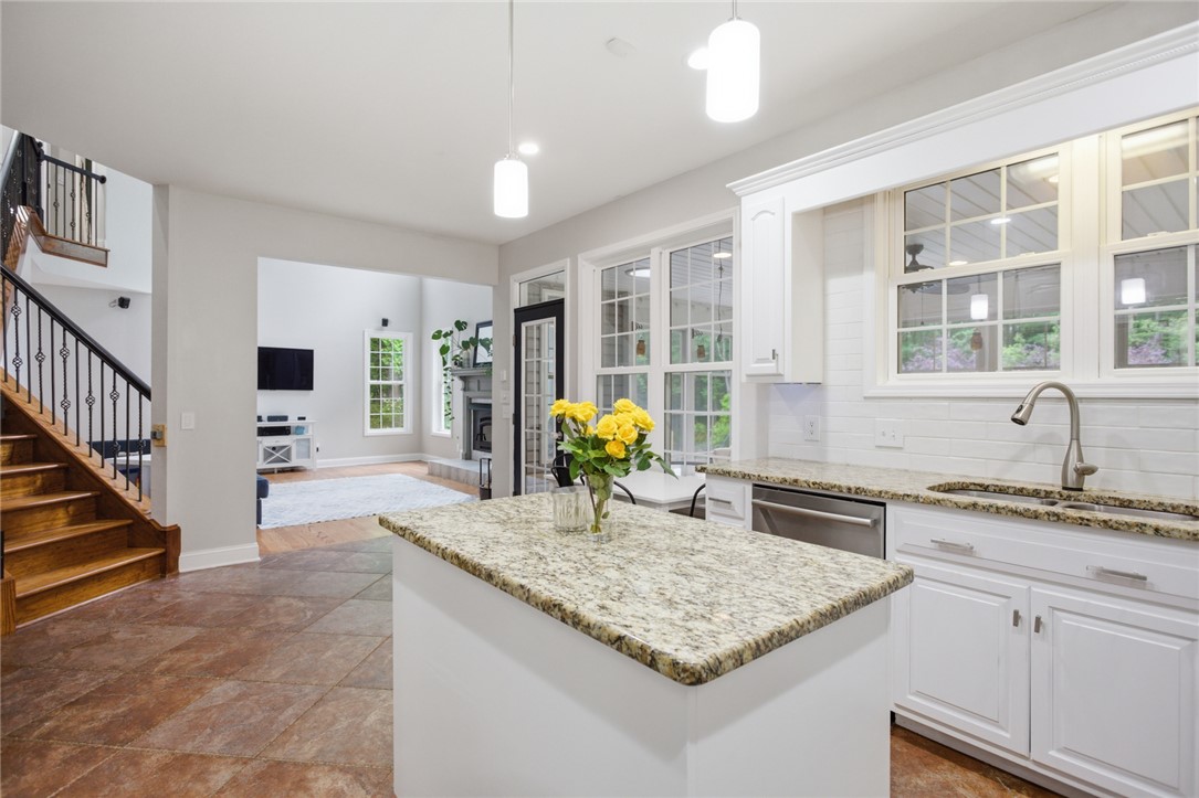 207 Devonhurst Drive Seneca, SC 29678 - Photo 6 of 50 Bright open-concept kitchen features a spacious island and gleaming countertops, seamlessly connecting to living areas.