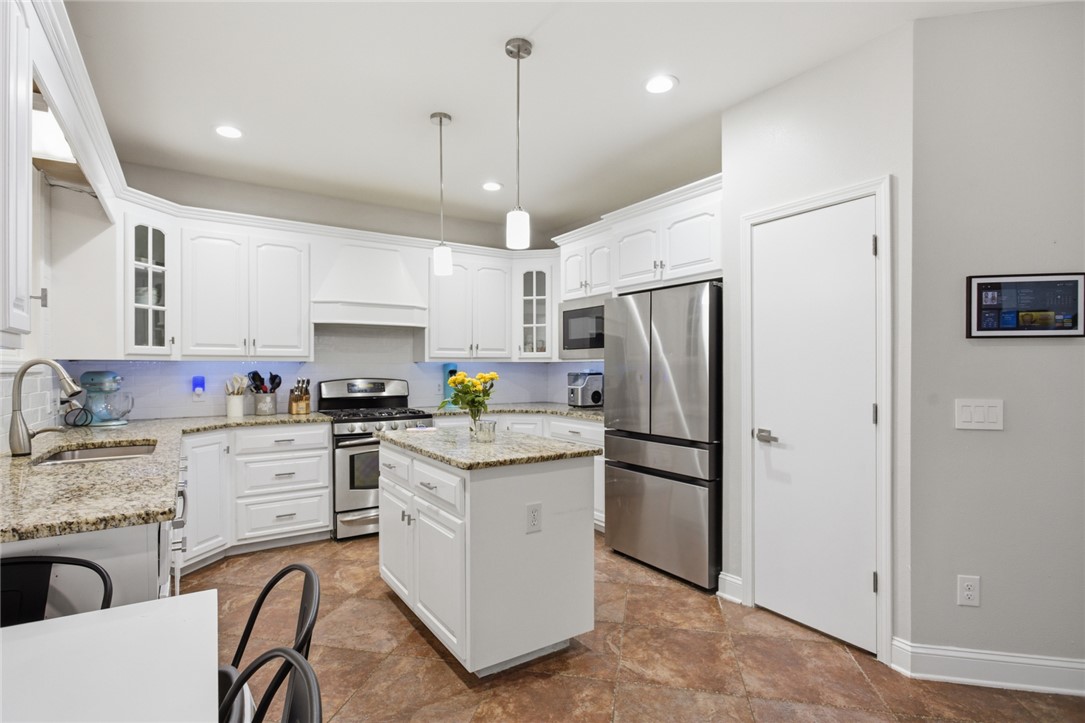 207 Devonhurst Drive Seneca, SC 29678 - Photo 8 of 50 This bright kitchen features an island, ample counter space, and modern appliances.
