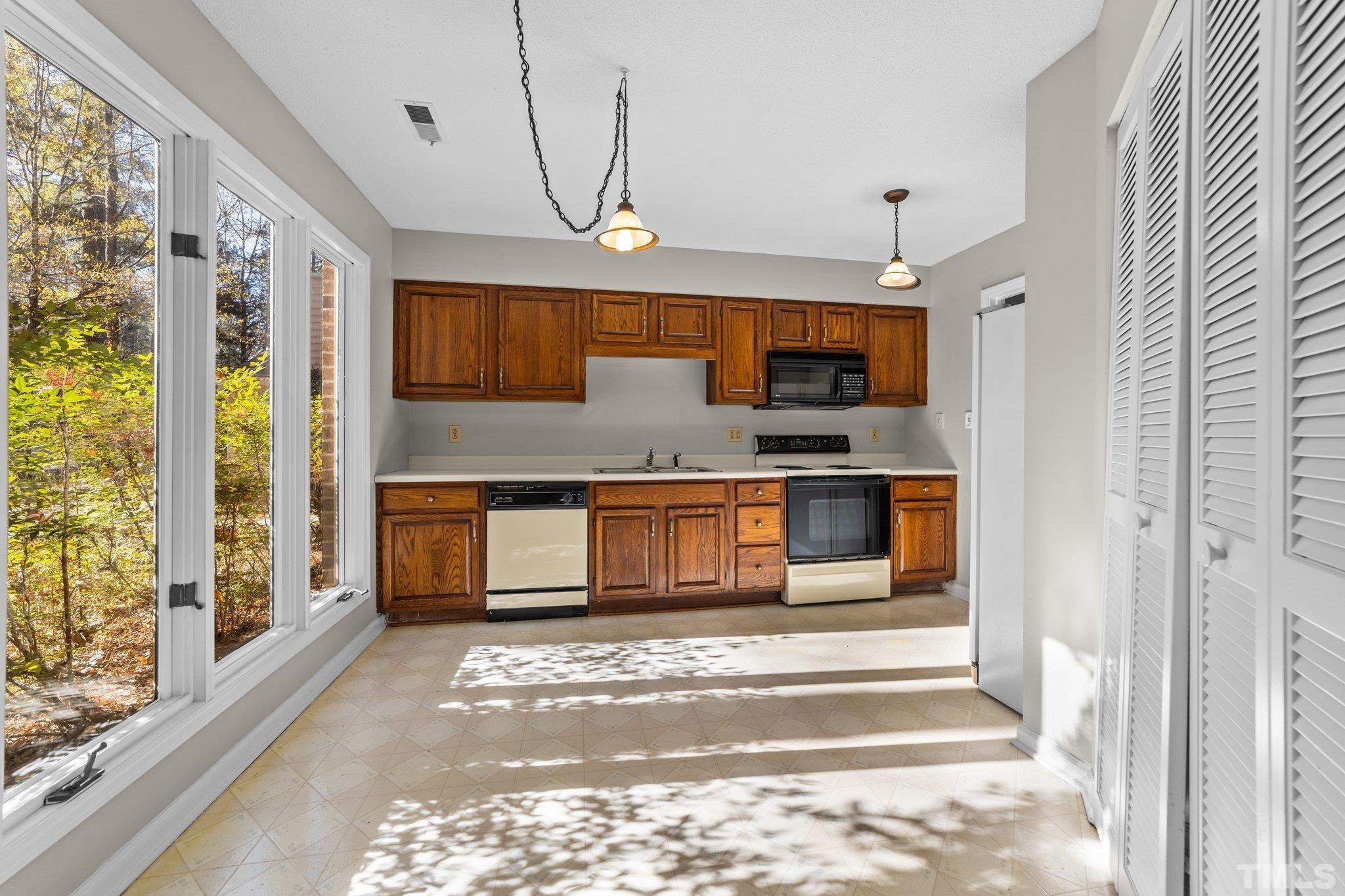 320 Summerfield Crossing Road Chapel Hill, NC 27514 - Photo 3 of 17 a kitchen with stainless steel appliances granite countertop a refrigerator and a stove