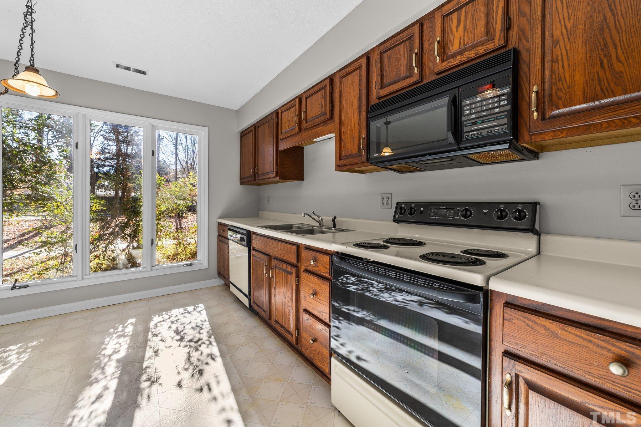 320 Summerfield Crossing Road Chapel Hill, NC 27514 - Photo 4 of 17 a kitchen with stainless steel appliances granite countertop a stove and a microwave
