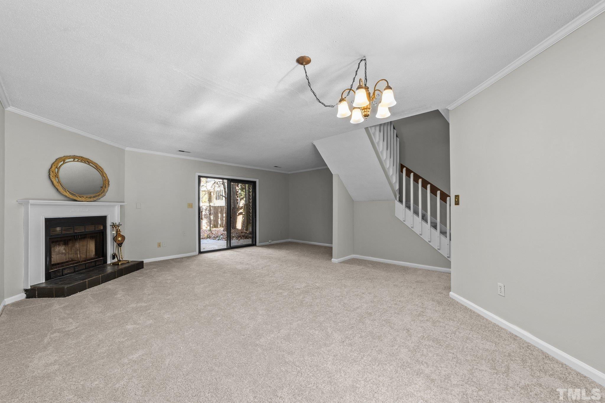 320 Summerfield Crossing Road Chapel Hill, NC 27514 - Photo 6 of 17 a view of an empty room with chandelier fan and fire place