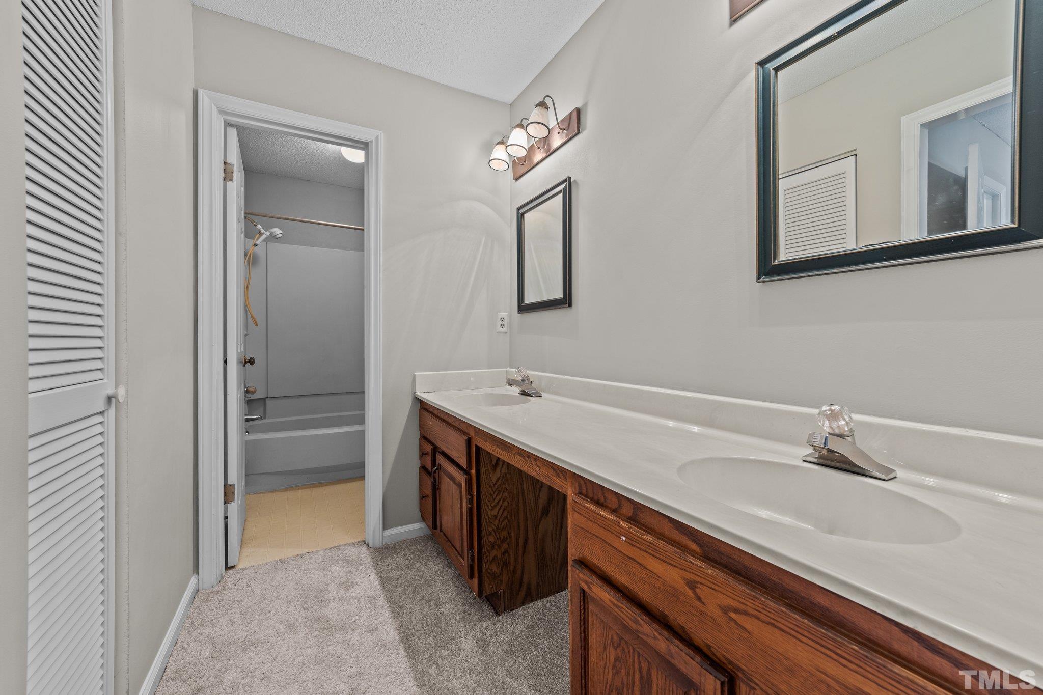 320 Summerfield Crossing Road Chapel Hill, NC 27514 - Photo 10 of 17 a spacious bathroom with a double vanity sink and mirror