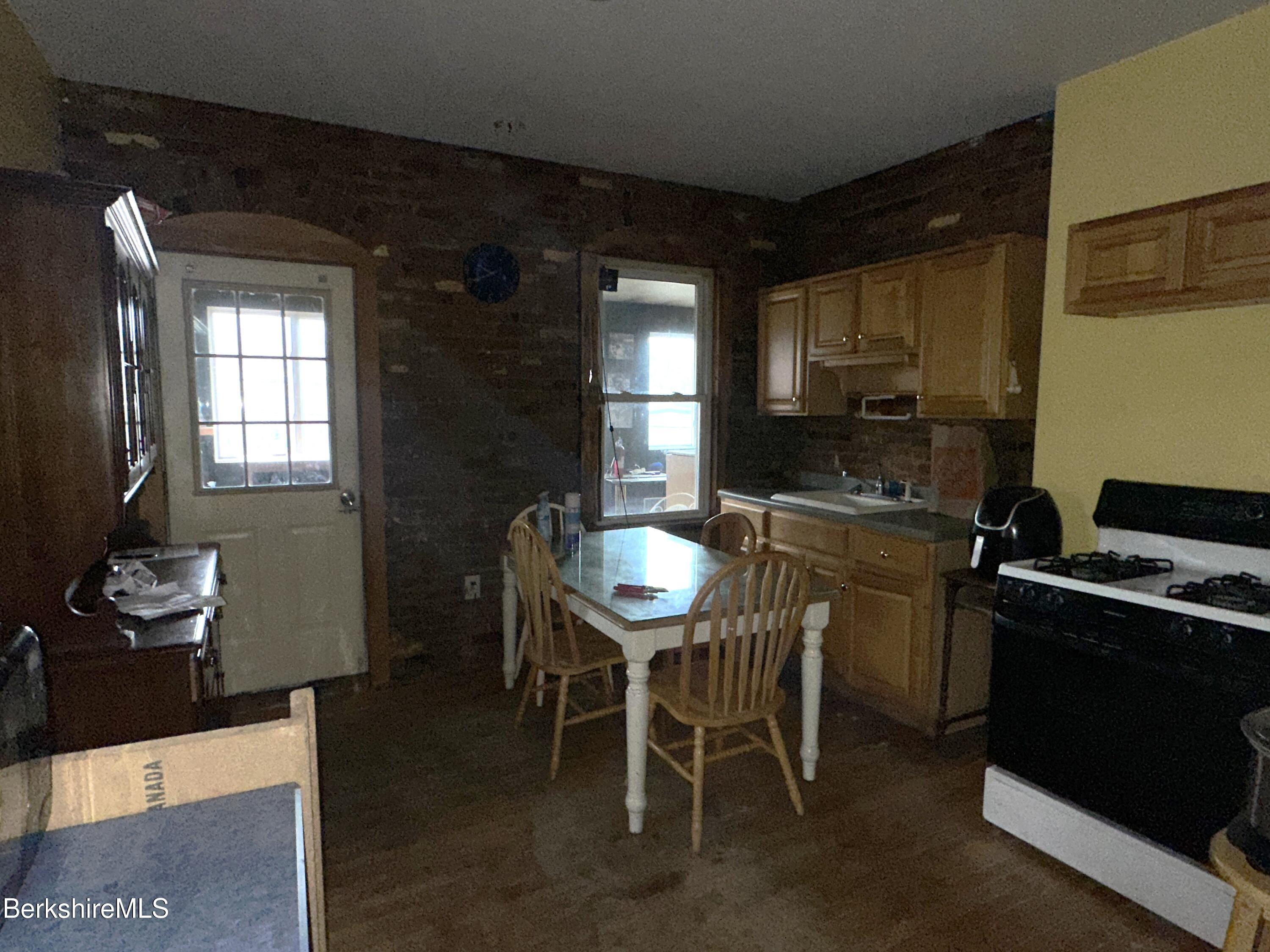 165-167 Appleton Avenue Pittsfield, MA 01201 - Photo 12 of 35 a kitchen with a dining table and chairs