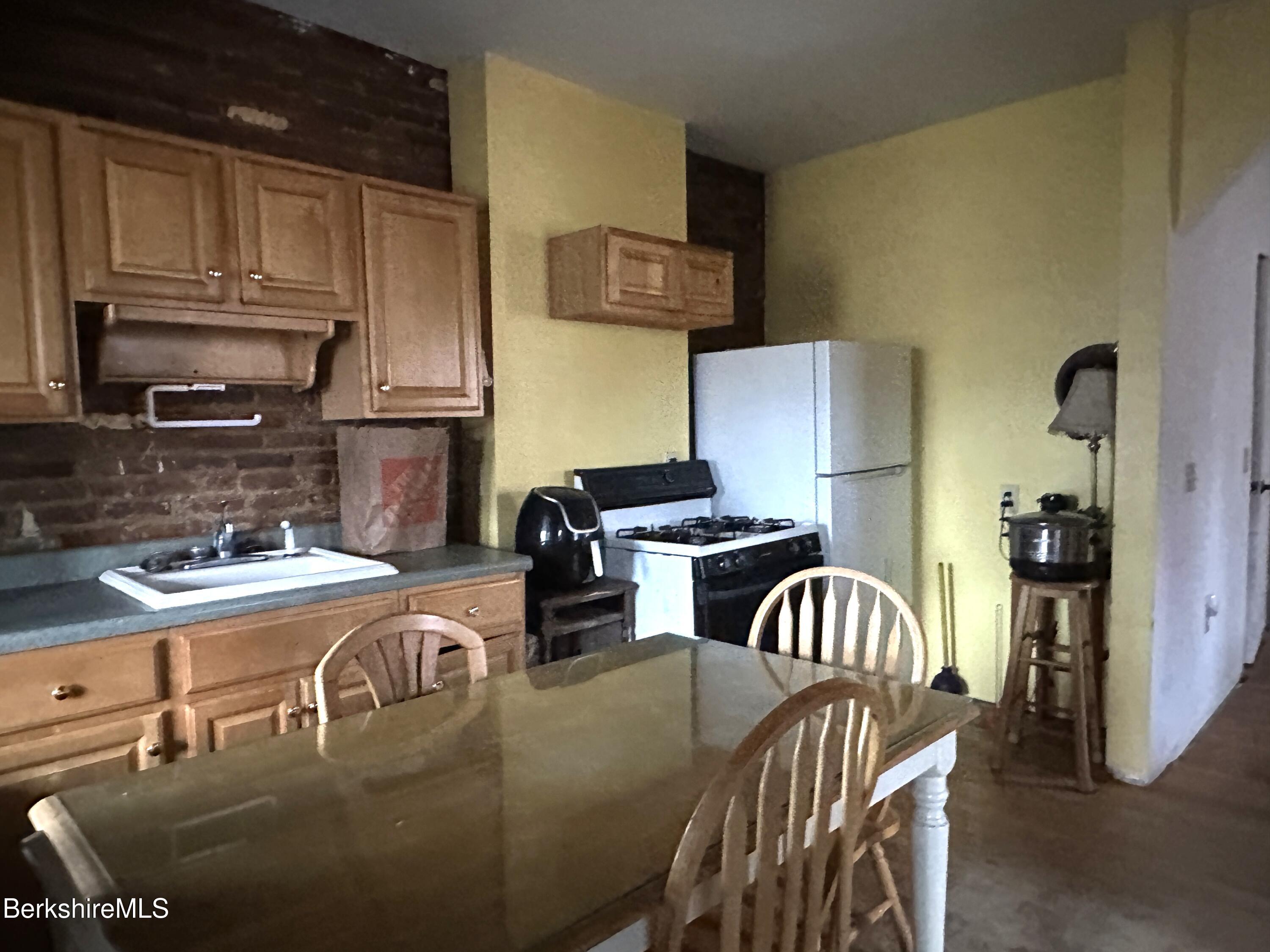165-167 Appleton Avenue Pittsfield, MA 01201 - Photo 13 of 35 a kitchen with stainless steel appliances granite countertop a sink a stove and refrigerator