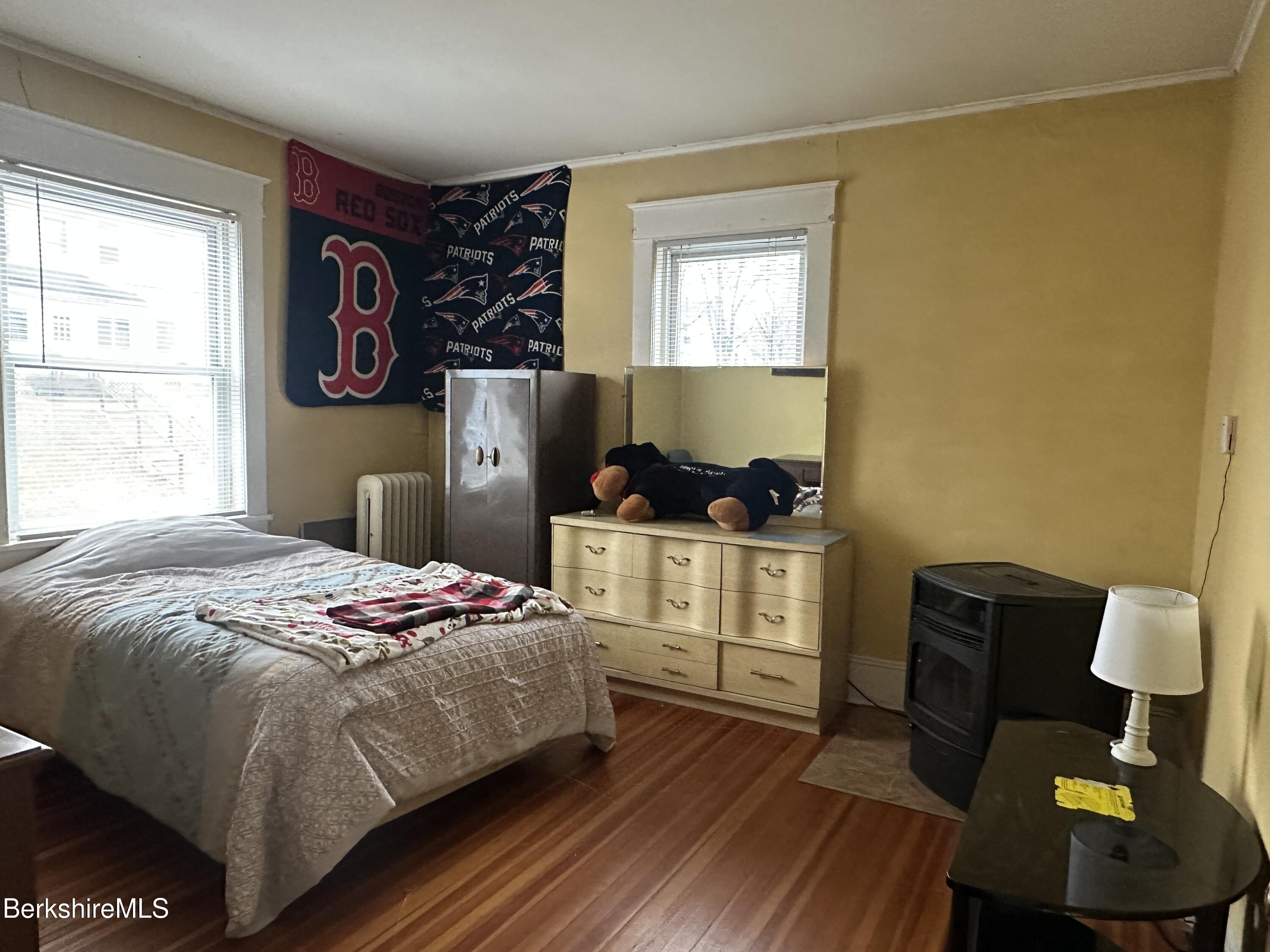 165-167 Appleton Avenue Pittsfield, MA 01201 - Photo 18 of 35 a bedroom with a bed and wooden floor