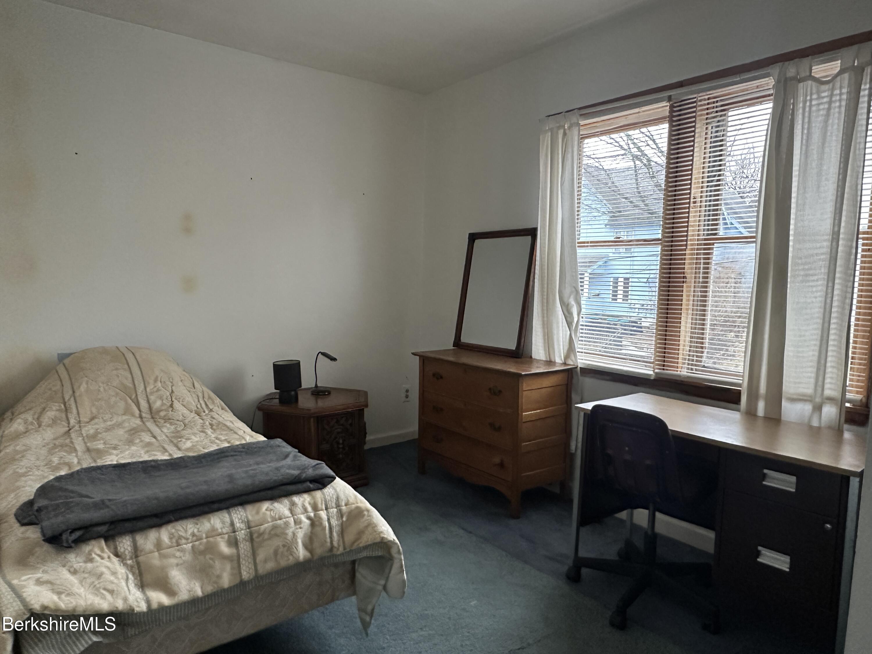 165-167 Appleton Avenue Pittsfield, MA 01201 - Photo 19 of 35 a bedroom with a bed chair and a window