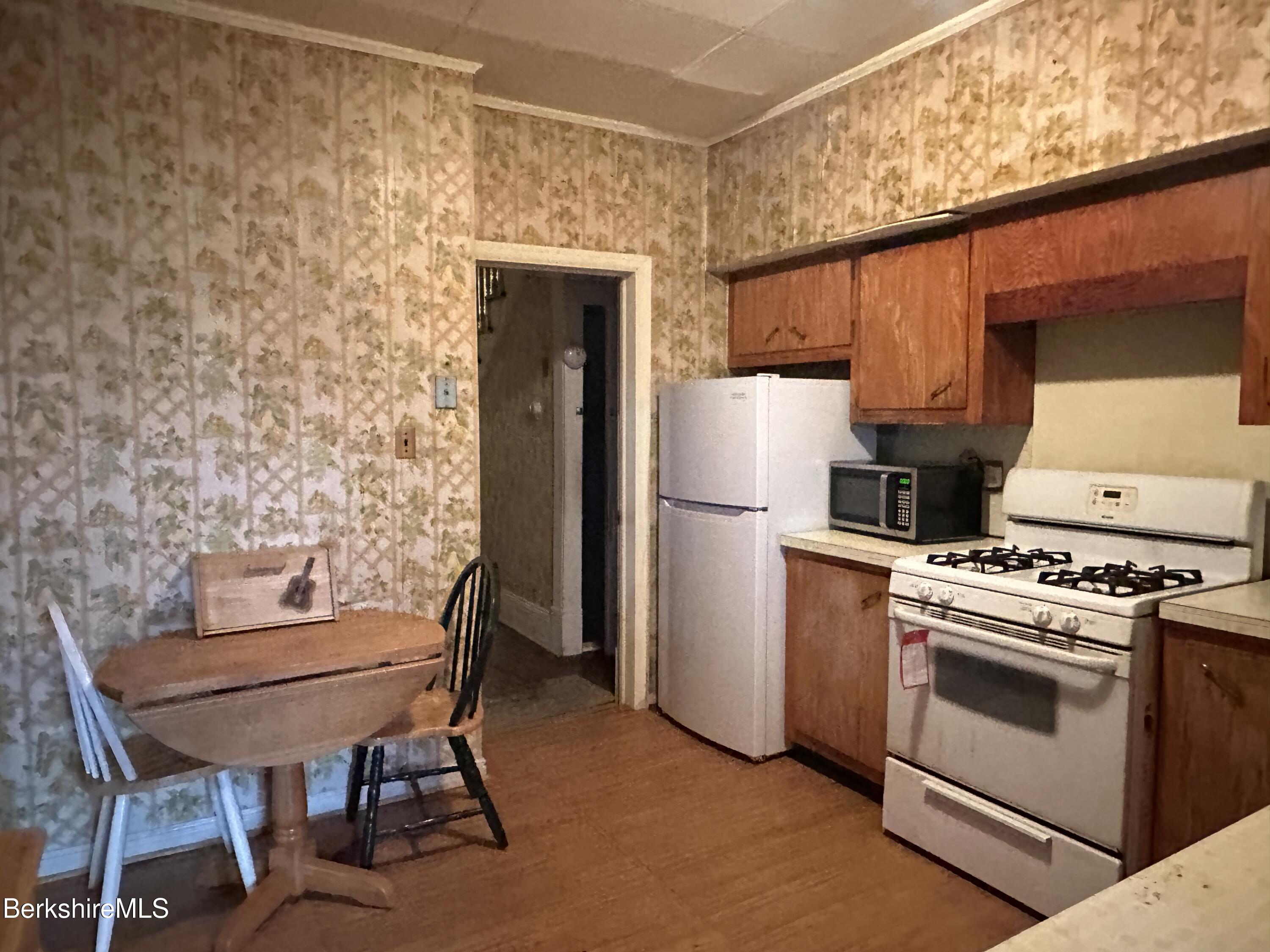165-167 Appleton Avenue Pittsfield, MA 01201 - Photo 21 of 35 a kitchen with a stove a refrigerator and a table