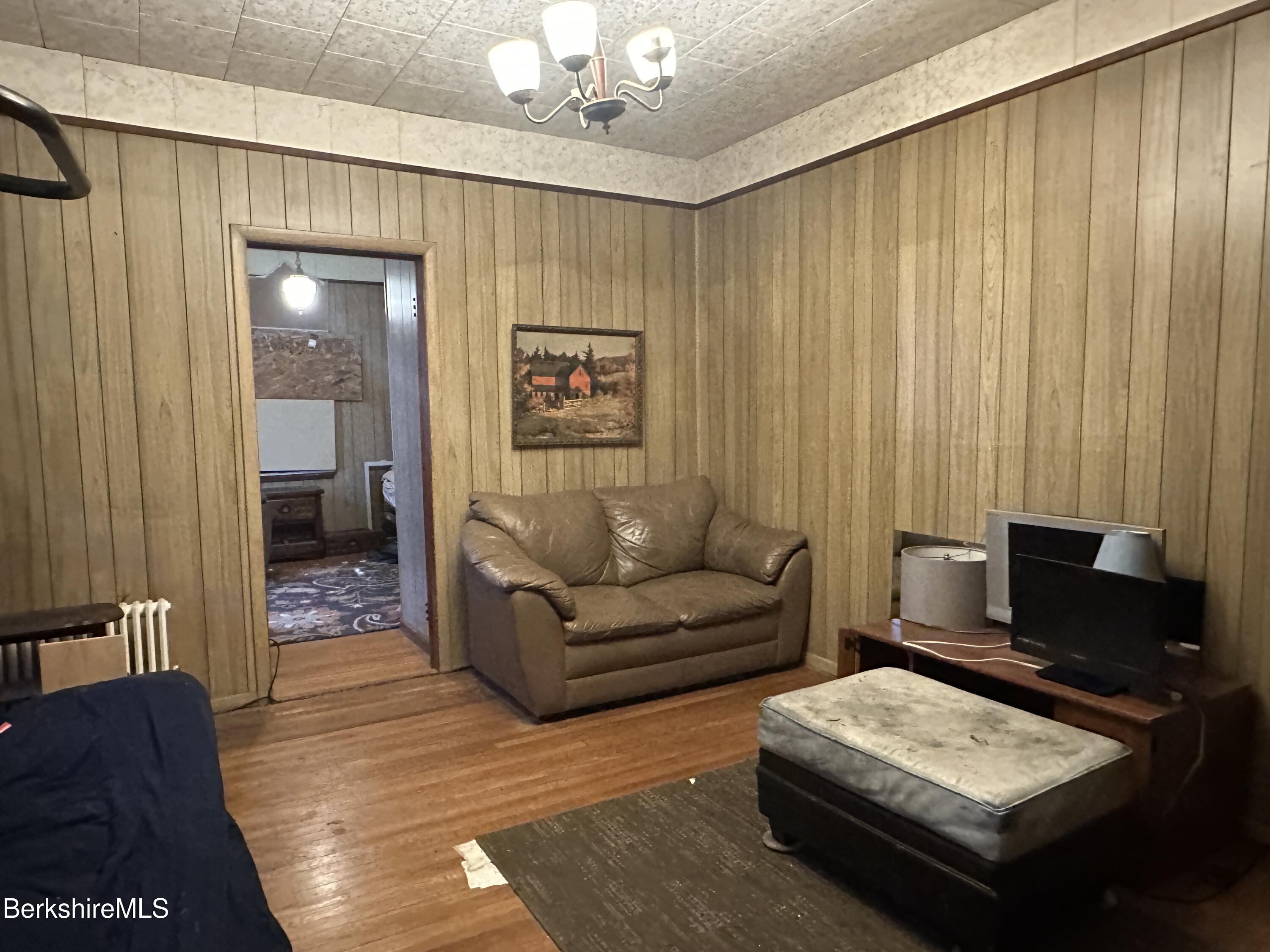 165-167 Appleton Avenue Pittsfield, MA 01201 - Photo 28 of 35 a living room with furniture and a chandelier