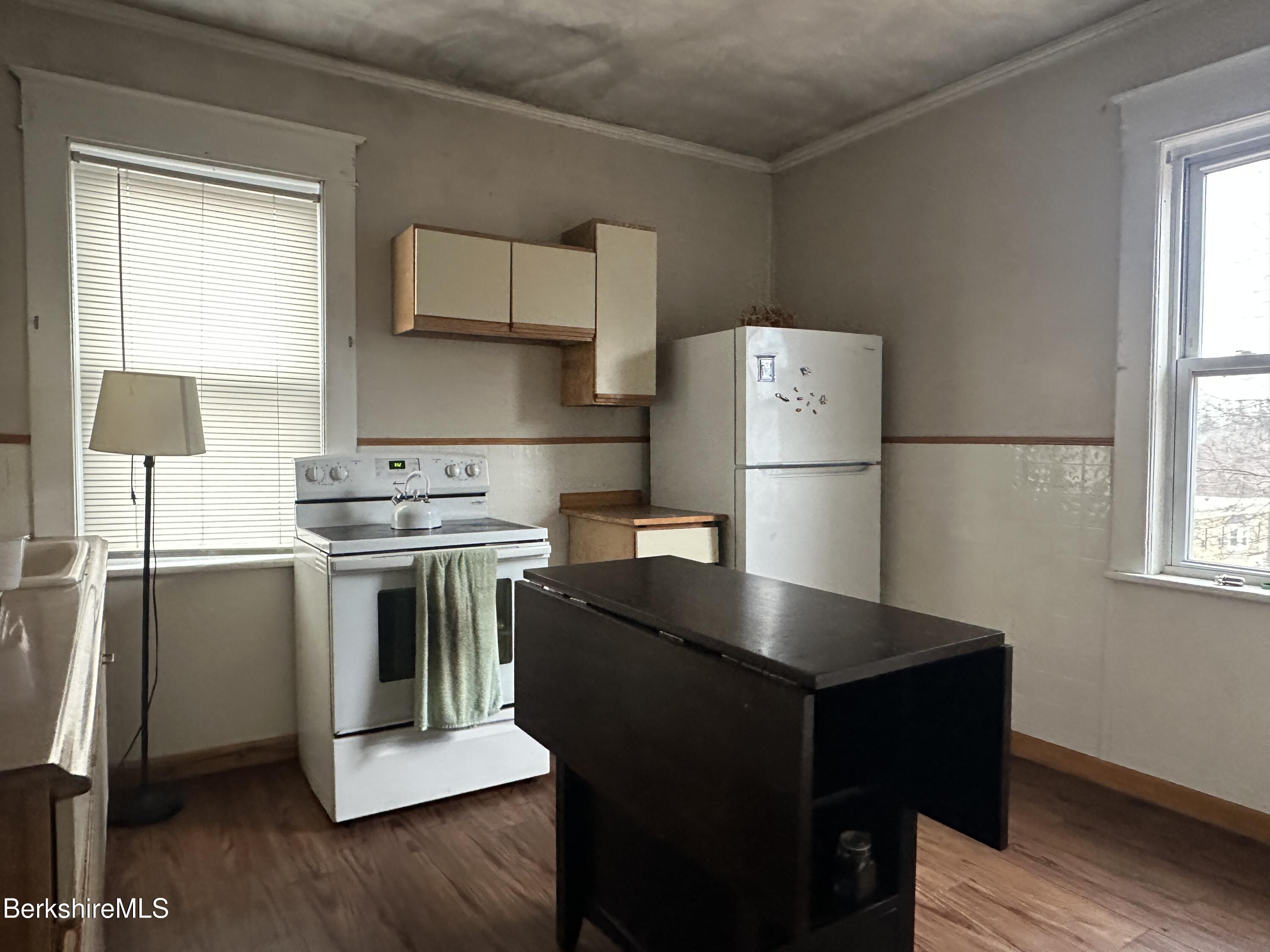 165-167 Appleton Avenue Pittsfield, MA 01201 - Photo 30 of 35 a kitchen with kitchen island a sink stove and refrigerator