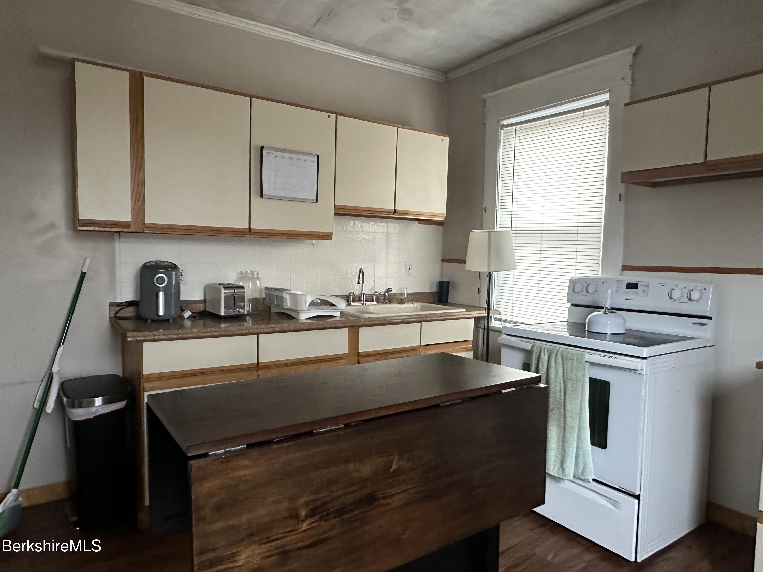 165-167 Appleton Avenue Pittsfield, MA 01201 - Photo 31 of 35 a kitchen with granite countertop a sink stove and cabinets