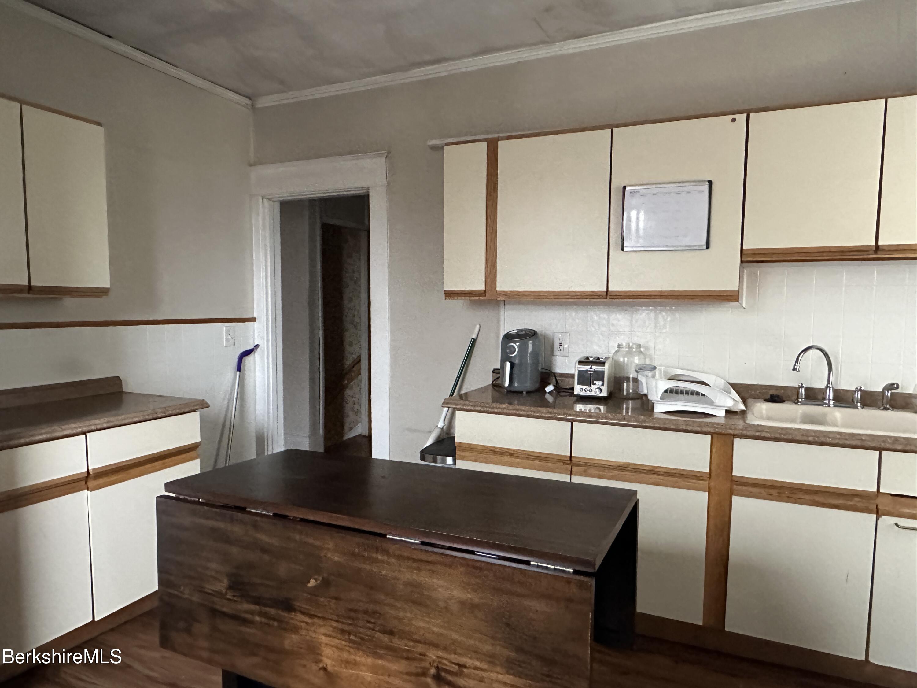 165-167 Appleton Avenue Pittsfield, MA 01201 - Photo 32 of 35 a kitchen with granite countertop a sink cabinets and stainless steel appliances