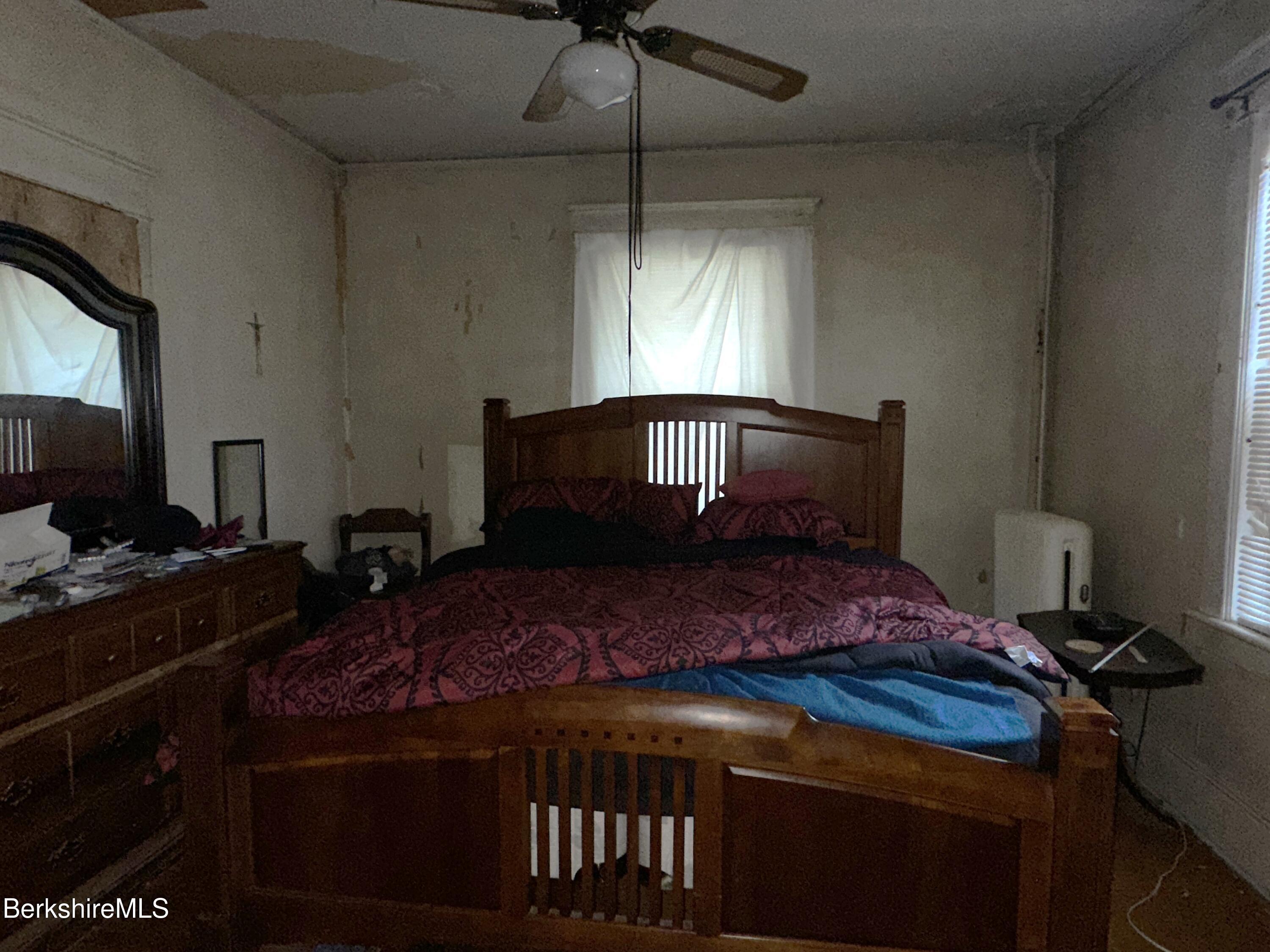 165-167 Appleton Avenue Pittsfield, MA 01201 - Photo 9 of 35 a bedroom with a bed and a chandelier