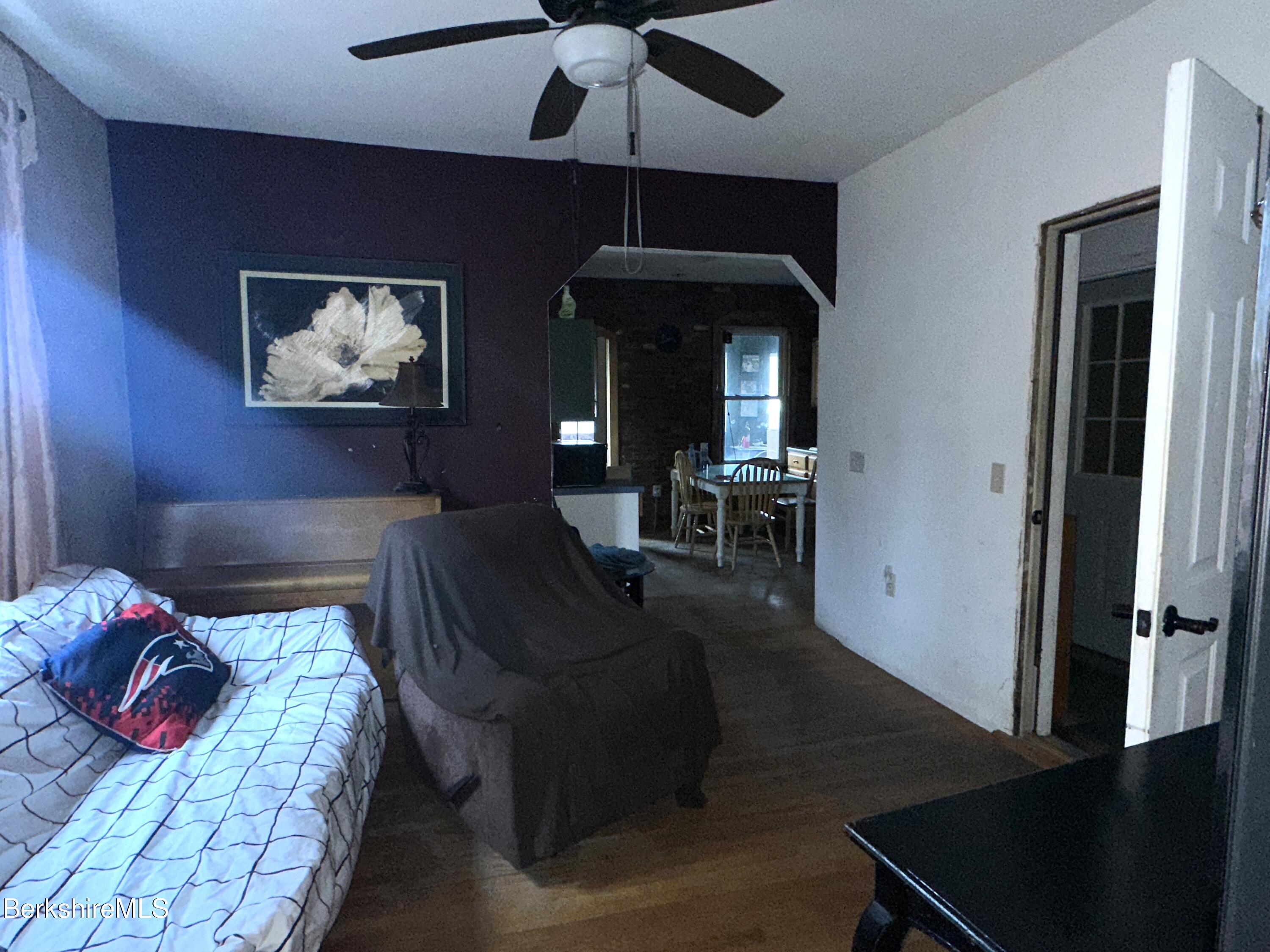 165-167 Appleton Avenue Pittsfield, MA 01201 - Photo 10 of 35 a bedroom with furniture and a chandelier