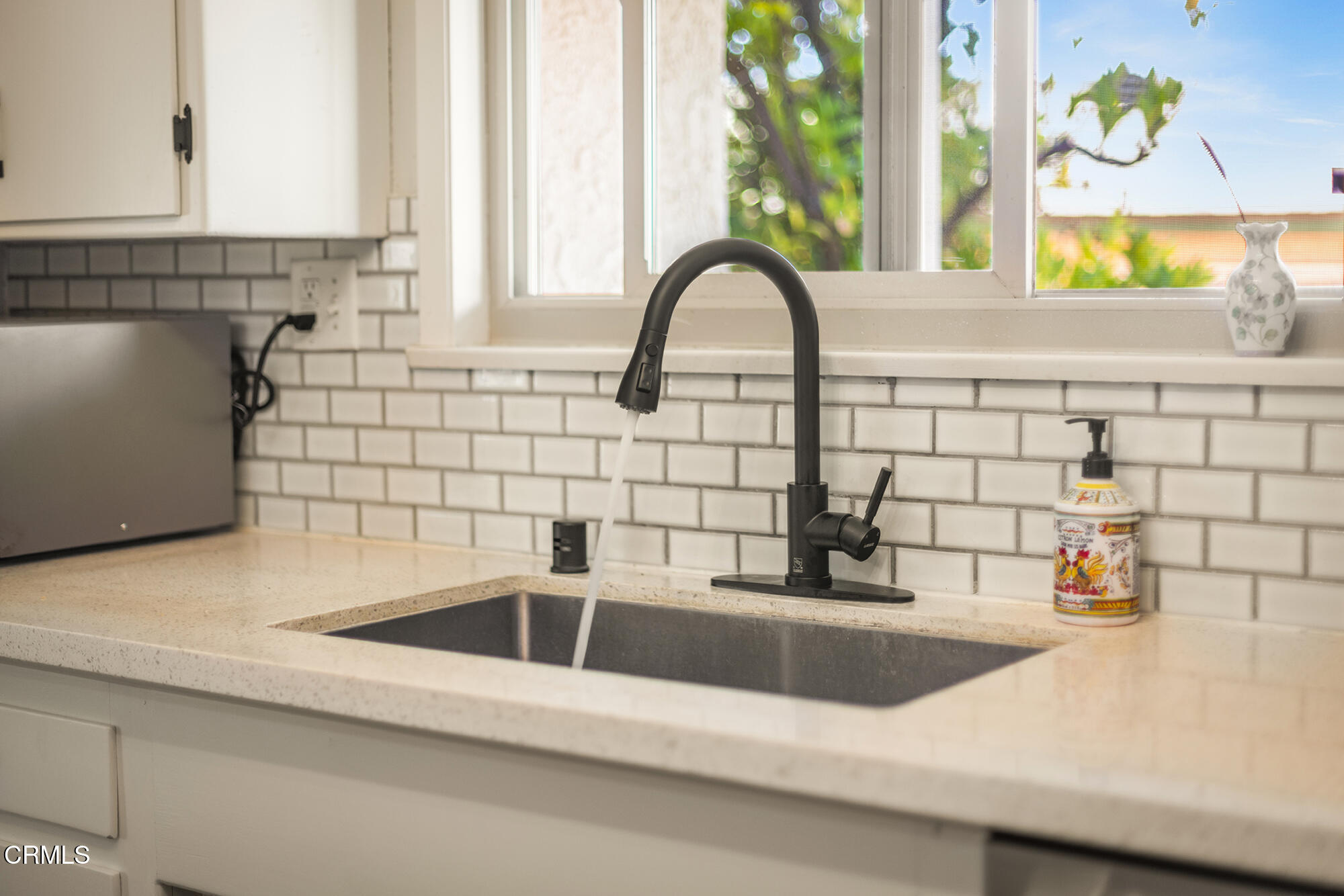 45 Rio Via Oak View, CA 93022 - Photo 15 of 34 a kitchen with a sink and a large window