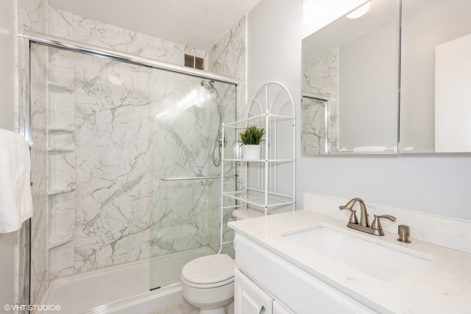 2015 South Finley Road, Unit 403 Lombard, IL 60148 - Photo 9 of 19 a bathroom with a sink toilet and shower