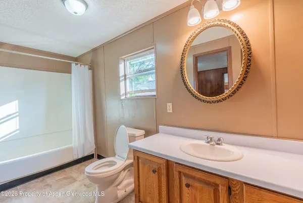a bathroom with a toilet a sink and a mirror