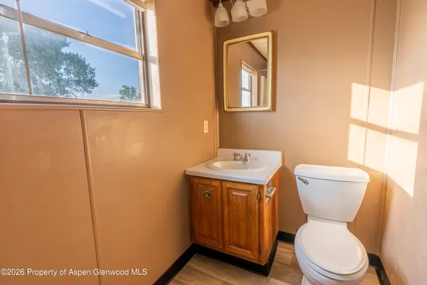 a bathroom with a toilet a sink and a window