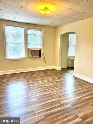 a view of a room with wooden floor and window
