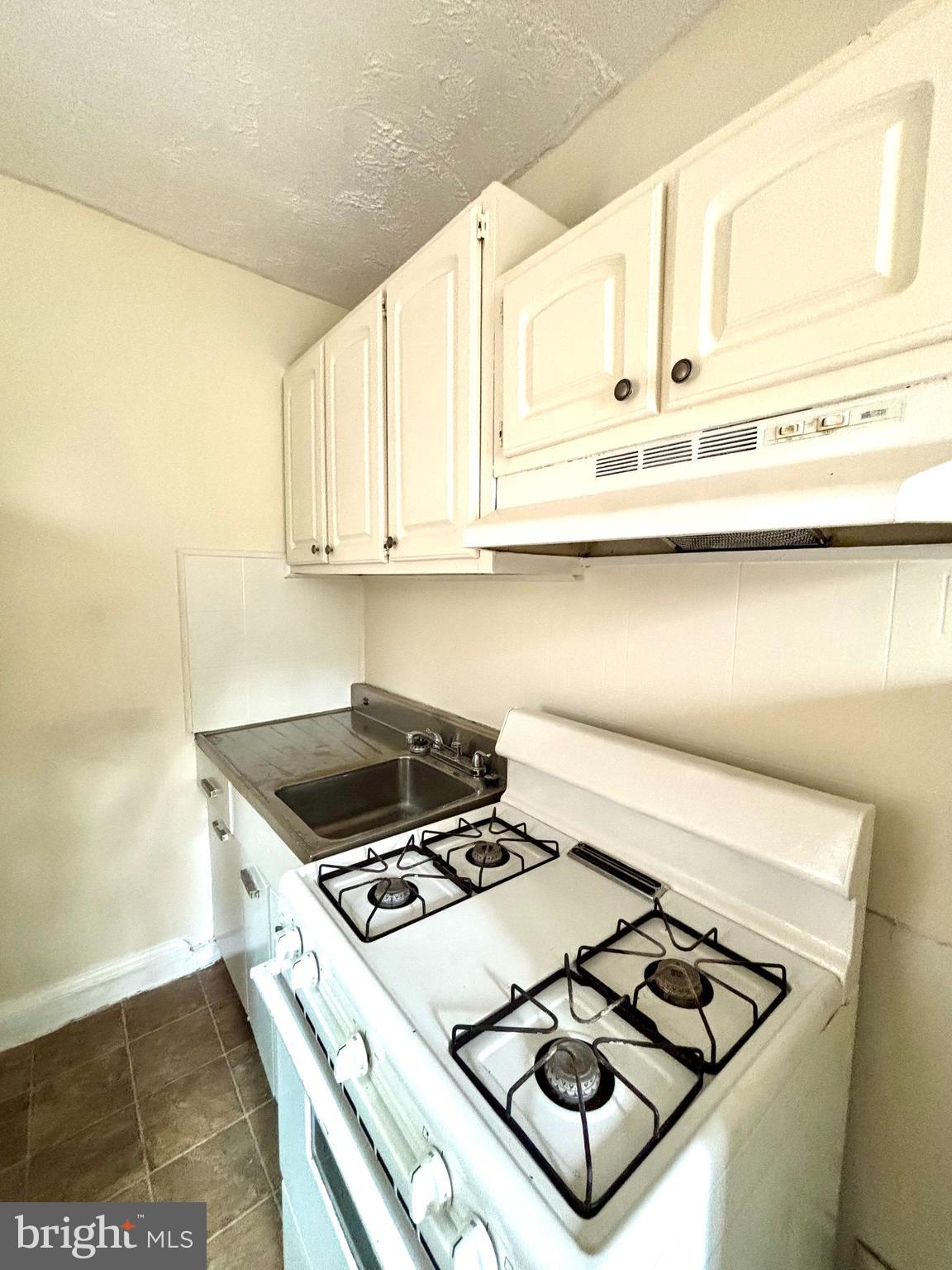5510 1st Street Northwest, Unit 6 Washington, DC 20011 - Photo 4 of 6 a stove top oven sitting inside of a kitchen