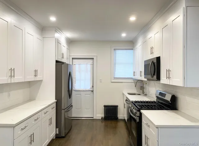 a kitchen with stainless steel appliances a refrigerator stove and sink