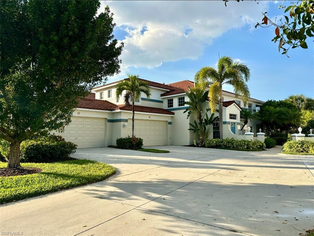 front view of house with a yard and potted plants