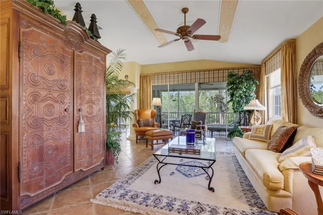 a living room with fireplace furniture and a large window