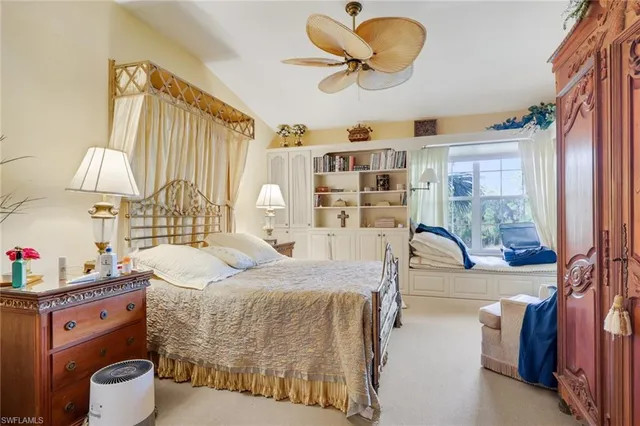 a large bedroom with a large bed and a window