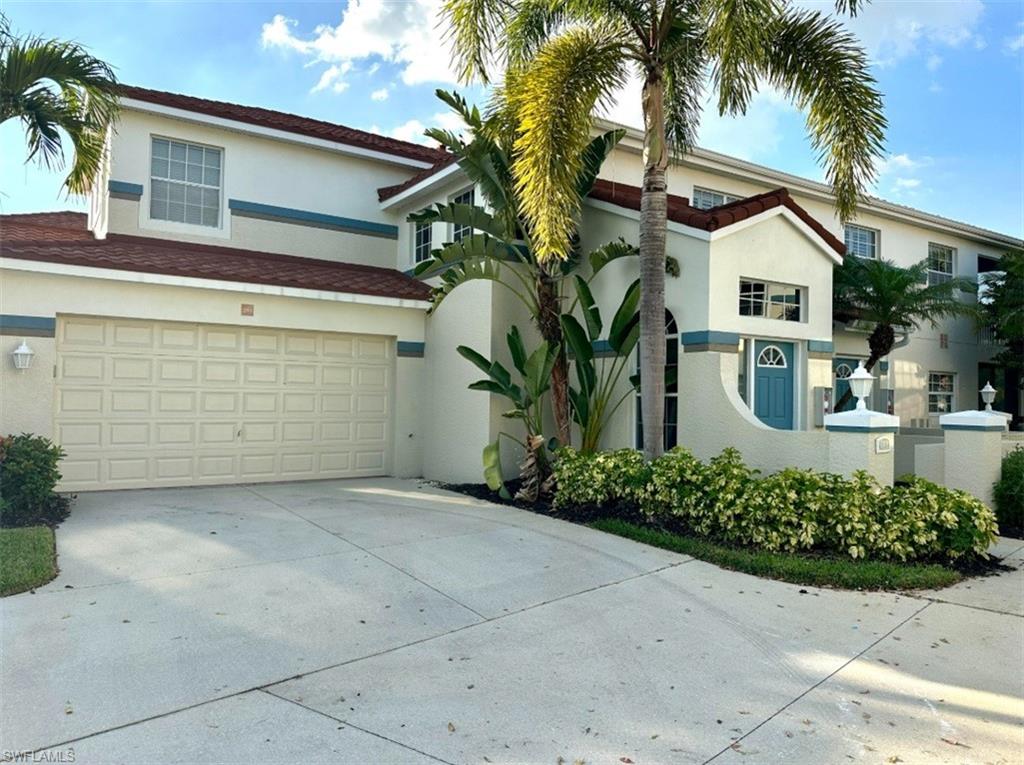 10801 Crooked River Road, Unit 203 Estero, FL 34135 - Photo 2 of 2 a view of white house with a yard and potted plants