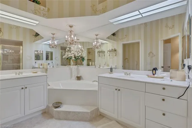 a bathroom with a double vanity sink mirror and shower