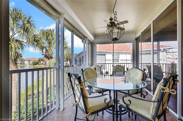 a view of a balcony with furniture and floor to ceiling window