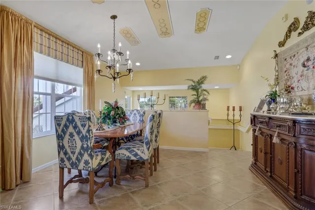 a view of a dining room with furniture and chandelier
